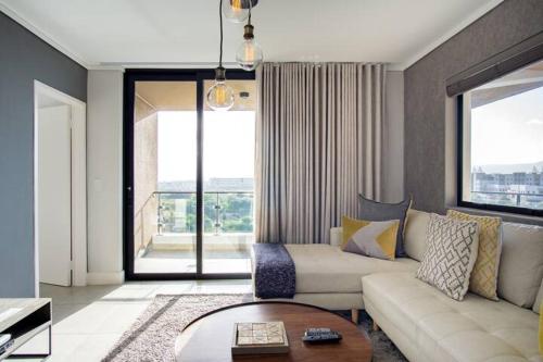 a living room with a couch and a table at Waters Edge Apartments in Cape Town