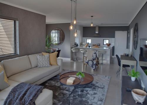 a living room with a couch and a table at Waters Edge Apartments in Cape Town