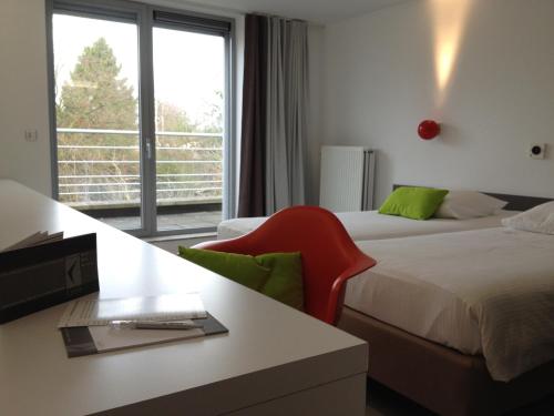 Voodi või voodid majutusasutuse Hotel Corbie Geel toas