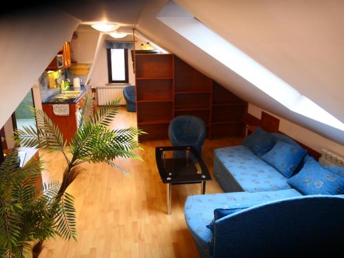 a living room with a blue couch and a table at Apartamenty u Łukasza in Zakopane
