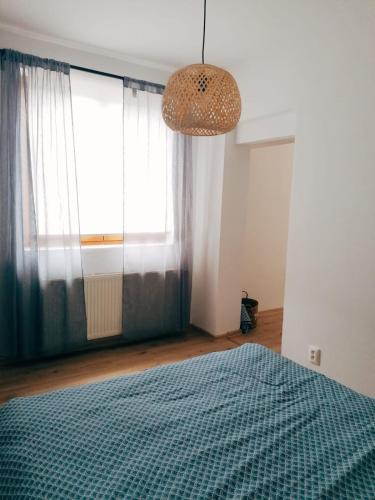 a bedroom with a bed and a large window at Apartment Dubnica Prejta 3 in Dubnica nad Váhom