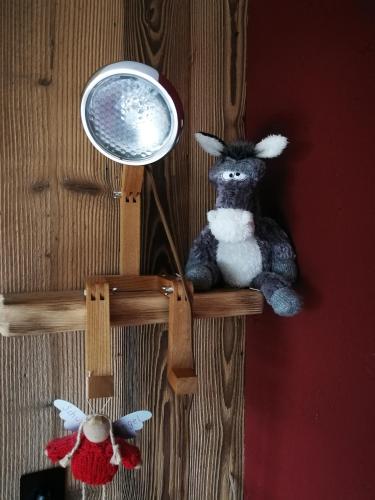 a stuffed animal on a wooden shelf with a mirror at Hotel Ehrwalderhof in Ehrwald