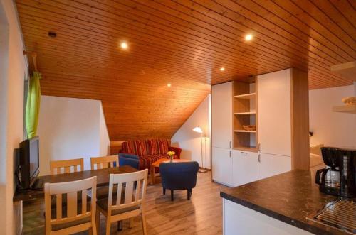 a kitchen and living room with a table and chairs at Schwarzwaldmädel-Ferienwohnungen in Todtnau