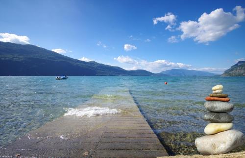 a stack of rocks sitting on a pier in the water at Hôtel L'Incomparable Aix-Les-Bains in Tresserves