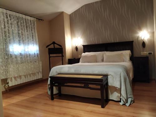 a bedroom with a large bed and a window at Hotel Palaterna in Pastrana