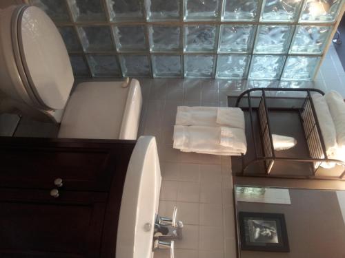 a bathroom with a toilet and a sink at Coral Reef Guesthouse in Fort Lauderdale