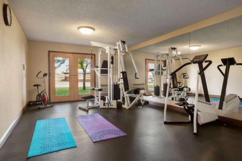 a gym with treadmills and machines in a room at Baymont by Wyndham Cortez in Cortez