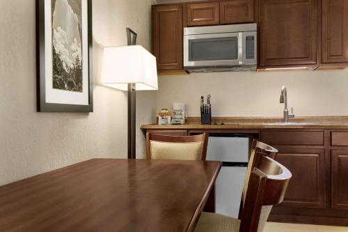 a kitchen with a table and a microwave at Baymont by Wyndham Cortez in Cortez