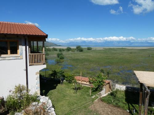 a house with a view of a field at Accommodation "MONTELAGO"- Virpazar,Skadar Lake in Virpazar
