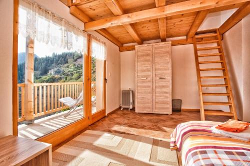 a bedroom with a bed and a large window at Accommodation "MONTELAGO"- Virpazar,Skadar Lake in Virpazar