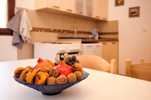 a bowl of fruit on a table in a kitchen at Accommodation "MONTELAGO"- Virpazar,Skadar Lake in Virpazar