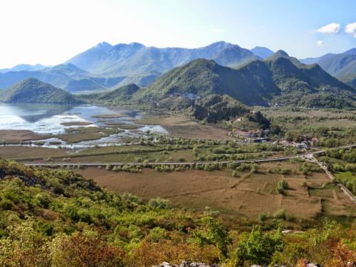an aerial view of a river and mountains at Accommodation "MONTELAGO"- Virpazar,Skadar Lake in Virpazar