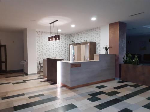 a lobby with a reception counter in a building at Hotel Uno in Ústí nad Orlicí