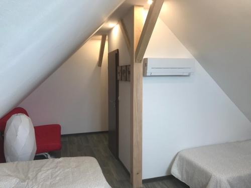 a attic room with a bed and a desk at Auberge du Parc in Marckolsheim
