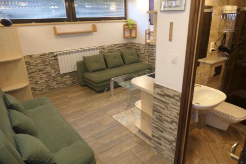 a living room with a couch and a sink at Apartamenty u Łukasza in Zakopane