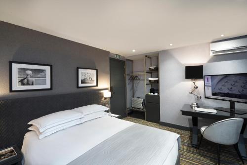 a hotel room with a bed and a television at President Hotel Athens in Athens