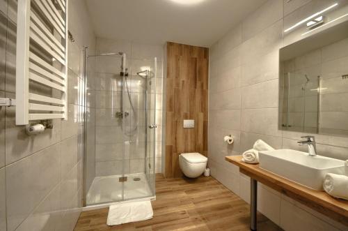 uma casa de banho com um chuveiro, um lavatório e um WC. em Gucio em Szczyrk