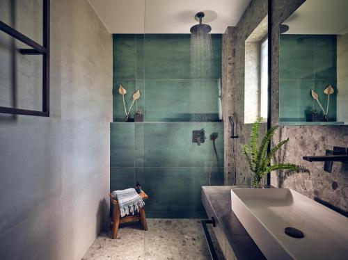 a bathroom with a tub and a sink and a shower at Cielo villas - An Authentic Mediterranean Living in Zakynthos Town