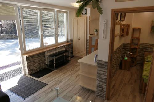 a living room with a fireplace and wooden floors at Apartamenty u Łukasza in Zakopane