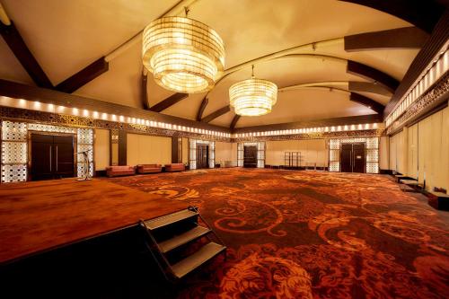 an empty ballroom with a large room with tables and chairs at Crowne Plaza New Delhi Rohini by IHG in New Delhi
