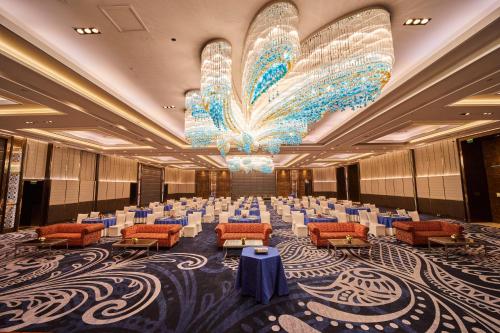 a large banquet hall with a large chandelier at Crowne Plaza New Delhi Rohini by IHG in New Delhi