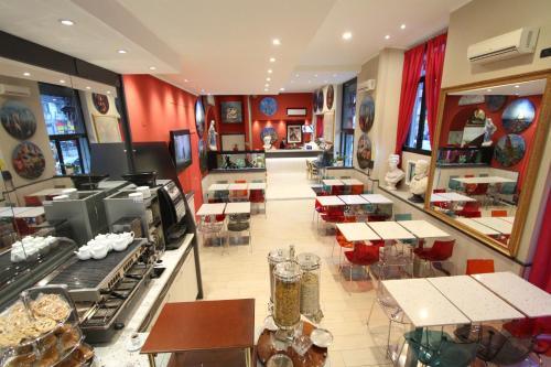 a restaurant with tables and chairs and red walls at Hotel Demo' in Milan