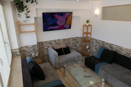 a living room with a couch and a table at Apartamenty u Łukasza in Zakopane