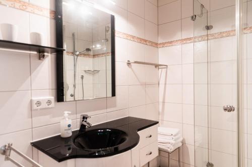a bathroom with a black sink and a shower at Ferienwohnung "Johann" in Meckenbeuren