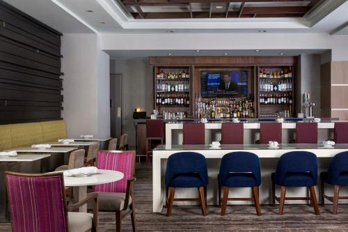 a restaurant with tables and chairs and a bar at Crowne Plaza Atlanta - Midtown by IHG in Atlanta