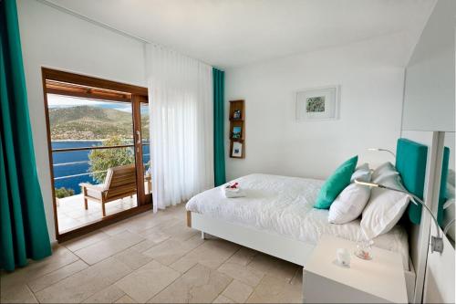 a bedroom with a bed and a balcony at Hotel Villa Mahal in Kalkan