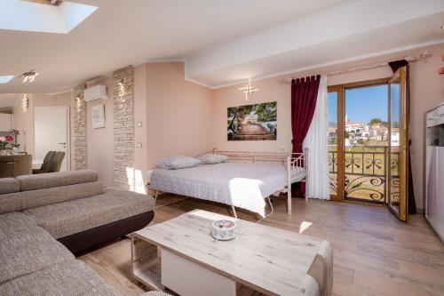 a living room with a bed and a couch at Oliva & Hedera Viridi in Kaštelir
