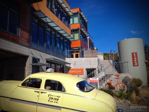 a yellow taxi cab parked in front of a building at Island Inn at 123 West in Friday Harbor