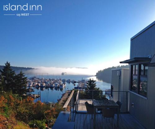 a balcony of a house with a view of a marina at Island Inn at 123 West in Friday Harbor