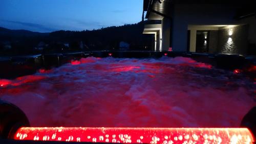 a hot tub filled with lots of red lights at DOMINO-APARTAMENTY Blue in Krościenko