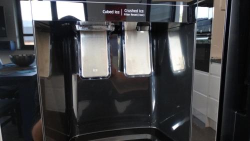 a coffee machine with a sign on top of it at DOMINO-APARTAMENTY Blue in Krościenko