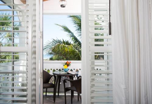 a dining room with a table and a view of the ocean at Port d'Hiver Bed and Breakfast in Melbourne Beach