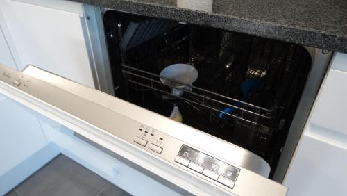 an oven with a dish rack inside of it at DOMINO-APARTAMENTY Red in Krościenko