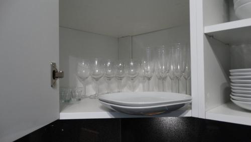 a room with many wine glasses on a shelf at DOMINO-APARTAMENTY Red in Krościenko