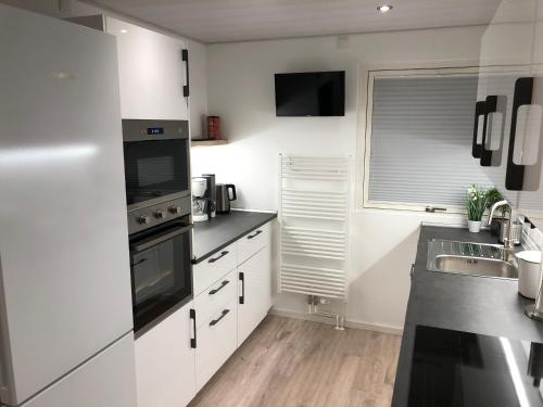 a kitchen with white cabinets and a sink at Nordstern in Büdelsdorf