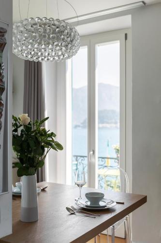 a dining room with a table and a chandelier at Royal Cadenabbia in Griante Cadenabbia