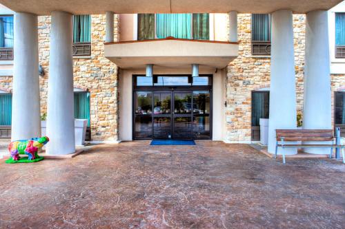 a lobby of a building with a door and a stuffed animal at Holiday Inn Express Hotel & Suites Austin NE-Hutto by IHG in Hutto