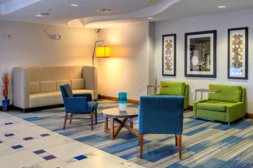 a waiting room with chairs and a table at Holiday Inn Express Hotel & Suites Austin NE-Hutto by IHG in Hutto
