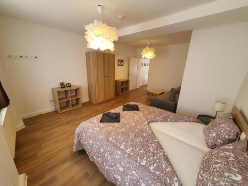 a bedroom with a bed and a dresser at PM CityAPART Lend in Graz