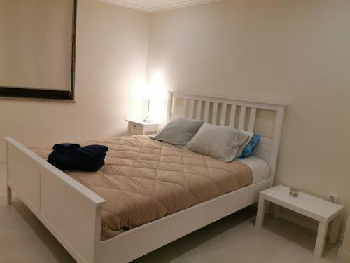 a bedroom with a large bed with two pillows at Isabel do Couto - casa de charme in Castro Daire