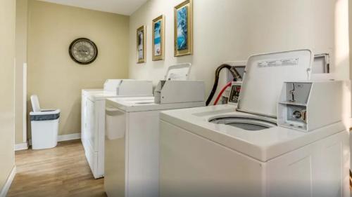 a row of washing machines in a laundry room at Lifes a beach on Myrtle Beach in Myrtle Beach