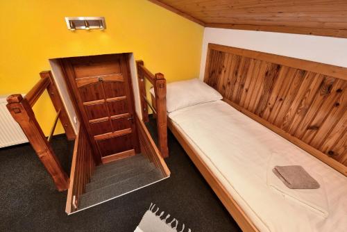 two twin beds in a room with yellow walls at Vila Martina in Poprad