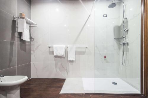 a bathroom with a shower and a toilet and a sink at Best Western Modena District in Campogalliano