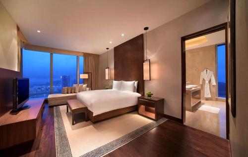 a bedroom with a large bed and a large window at Grand Hyatt Macau in Macau