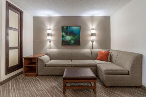 a living room with a couch and a table at Hyatt Place Richmond Arboretum in Richmond