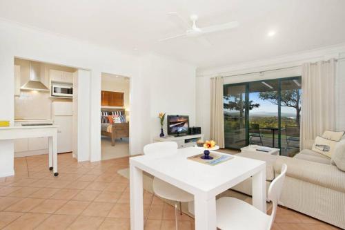 a white living room with a white table and chairs at Seascape The Haven in Scotts Head
